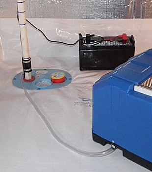 Closeup of a crawl space sump pump installed in Otto