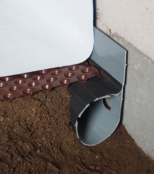 Closeup of a crawl space drainage system installed in Whittier
